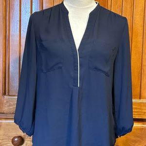 Sheer navy blue with white trim collar. 3/4 sleeve blouse